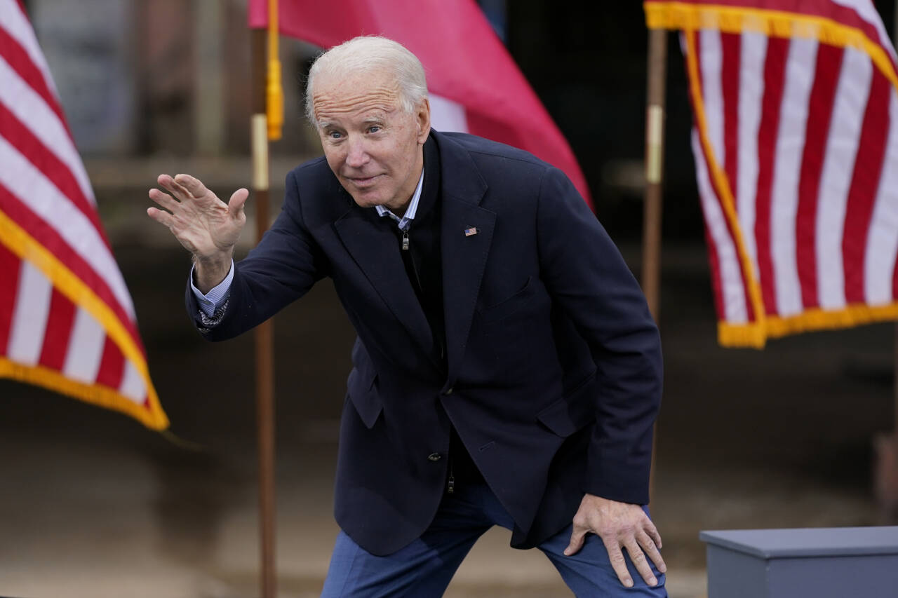 President-elect Joe Biden waves to supporters after speaking at a drive-in rally for Georgia Democratic candidates for U.S. Senate Raphael Warnock and Jon Ossoff, Tuesday, Dec. 15, 2020, in Atlanta. (AP Photo/Patrick Semansky)
