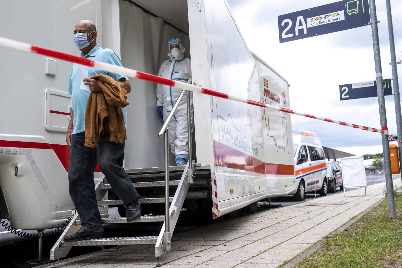 En mann forlater en mobil teststasjon for koronavirus ved Köln Bonn-flyplassen i Köln lørdag. Tyskland har innført gratis koronatester for personer som ankommer fra land som regnes som risikoområder. Foto: Marius Becker / AP / NTB scanpix