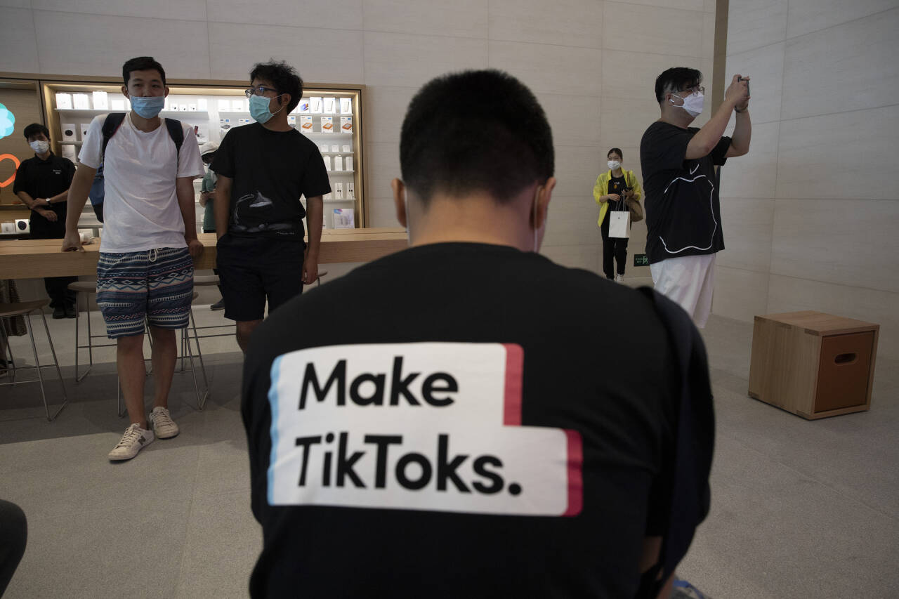 En mann promoterte Tiktok i en Apple-butikk i Kina i sommer. Arkivfoto: Ng Han Guan / NTB