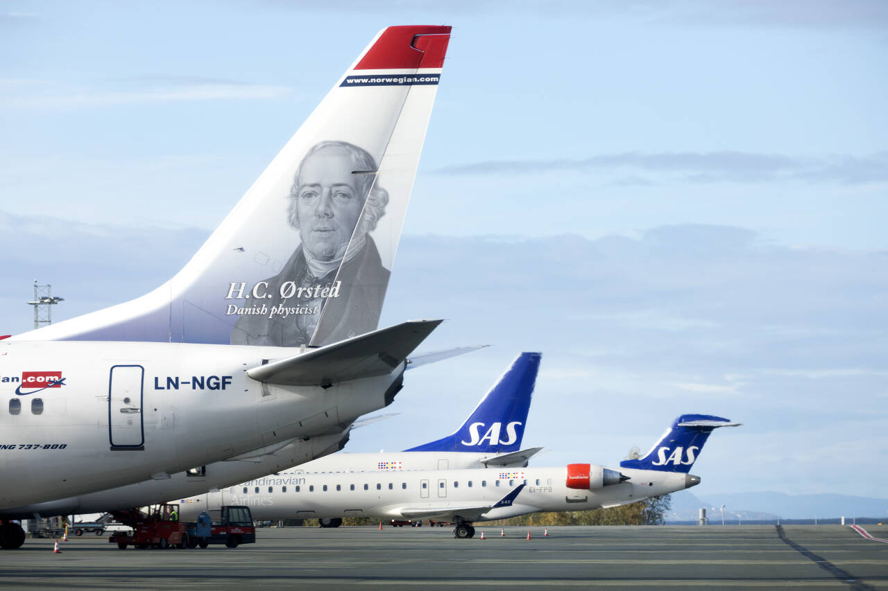 Både Norwegian og SAS innfører påbud om munnbind på sine flyginger. Foto: Gorm Kallestad / NTB