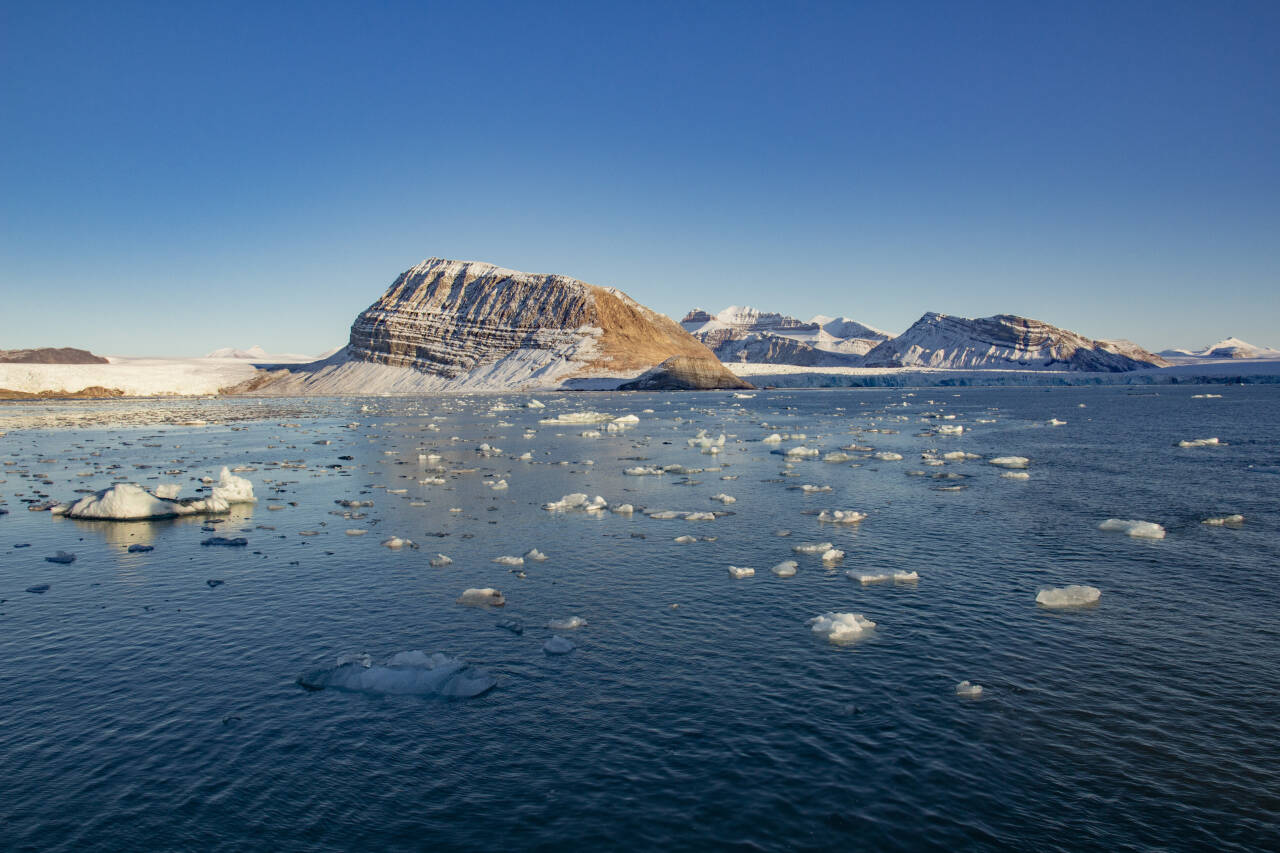 Forskere i Norge og Finland har studert temperaturdata fra Arktis og kommet fram til at regionen varmes opp betydelig raskere enn det man hittil har trodd. Isen på bildet kommer fra isbreer som kalver ut i Kongsfjorden ved Ny-Ålesund på Svalbard. Arkivfoto: Are Føli / NTB