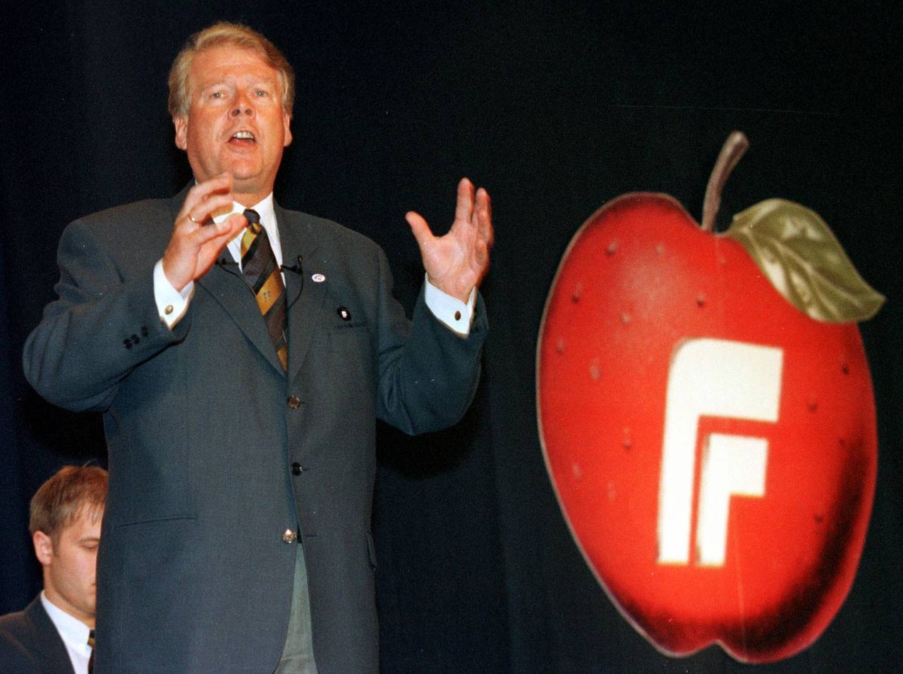 Tidligere partileder Carl I. Hagen med en tidligere utgave av partiets eplelogo. Apples første eple-logo ble tatt i bruk i 1977, mens Frp ikke kom med eplet sitt før tidlig på 1990-tallet. Arkivfoto: Lise Åserud / NTB scanpix