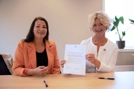 Fungerende generalsekretær i FN-forbindelsen Ellen Sporstøl (t.v.) og fylkesordfører Tove-Lise Torve skrev under kontrakten. Foto: Møre og Romsdal fylkeskommune